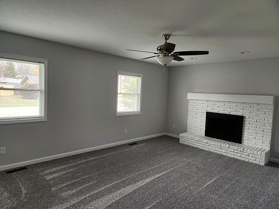 Lots of Natural Light and a beautiful fireplace with a Gas Log in the Living Room