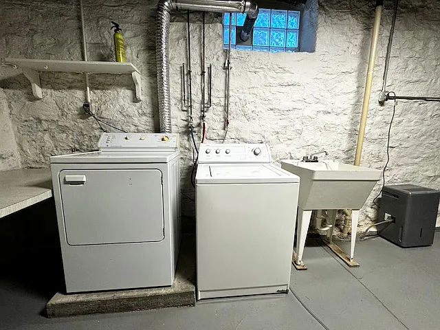 Washer, dryer, utility sink, dehumidifier in basement