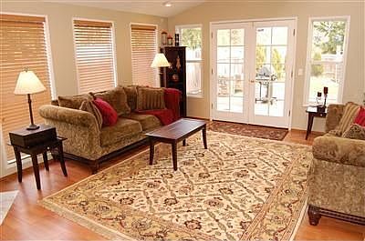 Large living room w/ vaulted ceiling, skylights, Pergo flooring, French-doors