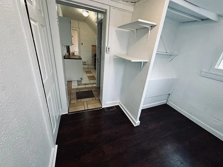 Bedroom, black out curtains and sheer curtains provided, light filled room. Laminate wood floors. 
North facing window.