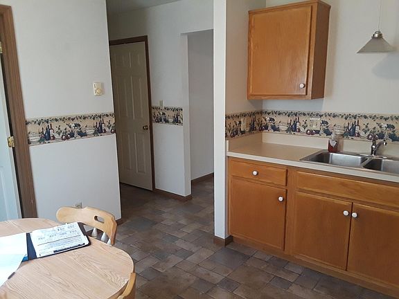 Kitchen view.  1/2 bath to left, view of basement door, and 