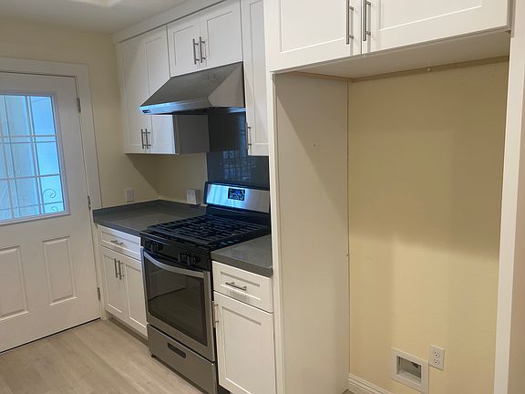 Kitchen has Stainless appliances and leads to the balcony.