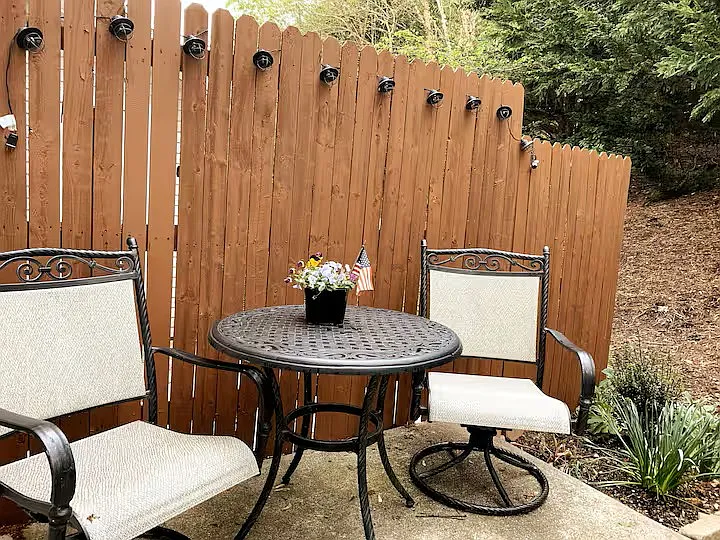 Back patio with table and chairs. Two additional chairs not shown. Outdoor lights.