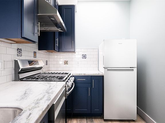 Renovated kitchen. Marble countertops, dishwasher, hood and 5 burner stove.