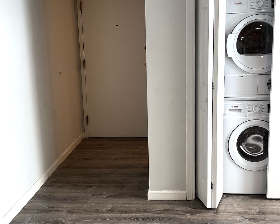 Entryway and partial living room shot with in-unit laundry