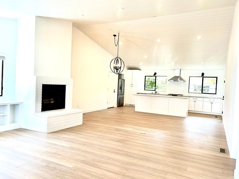 Large open floor plan with wood burning fireplace