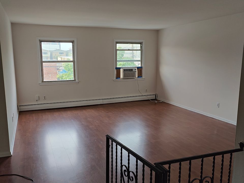 Large sunny living room, perfect for relaxing or studying. Note the affordable natural gas baseboard heat.