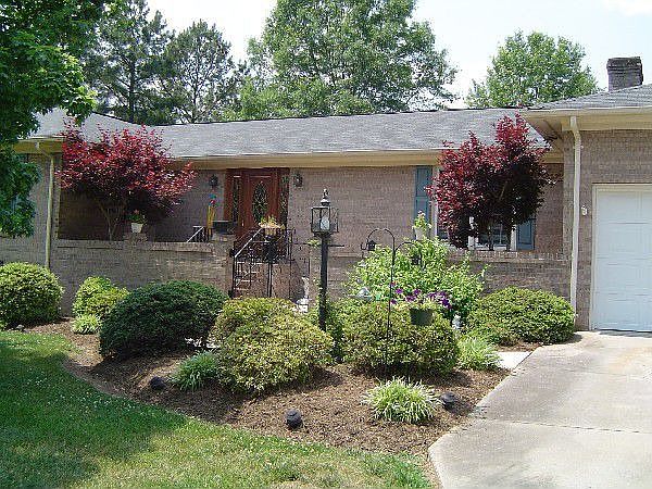 Front and back bricked-in patios! Extensive landscaping!