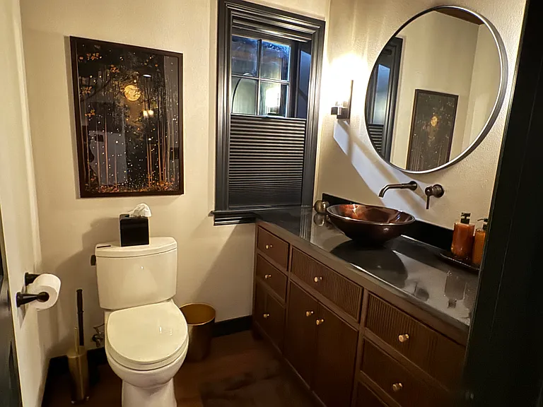 Downstairs powder room with vessel sink and thoughtfully designed finishes.