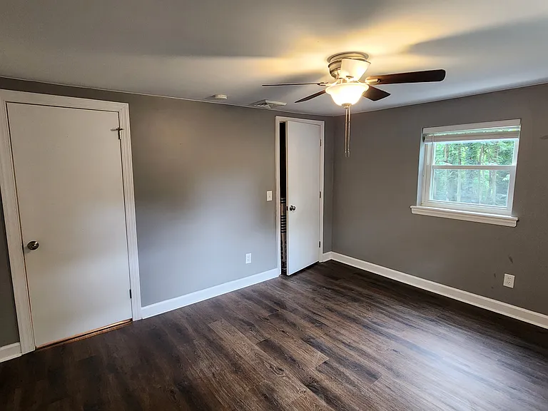 Bedroom #2. Door far left goes to bonus room/laundry, center left door goes to kitchen, door center/right closet.