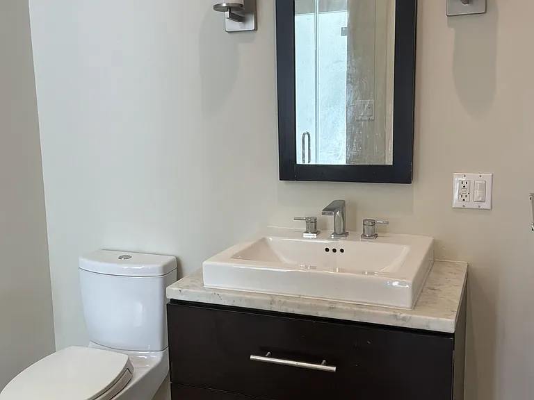 Full bathroom off kitchen with walk-through closet to front bedroom.