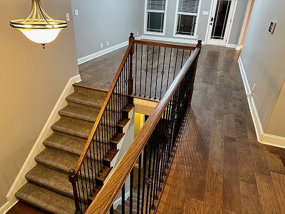 standing in office, picture of stairs at front door