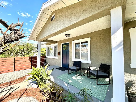 The inviting front porch with rockers is a Craftsman bungalow highlight.