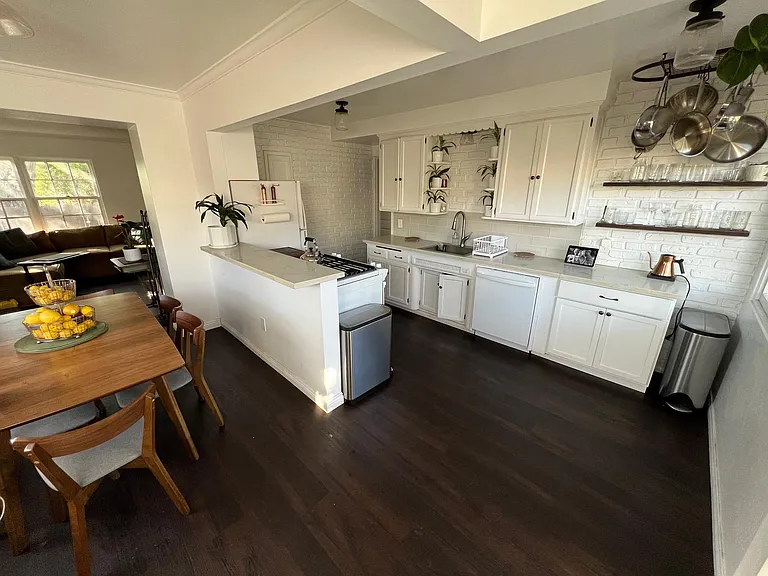 View of kitchen and dining area from back patio door