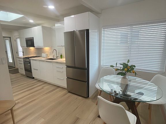 Kitchen with apartment size stove/oven/microwave and fridge. No dishwasher.