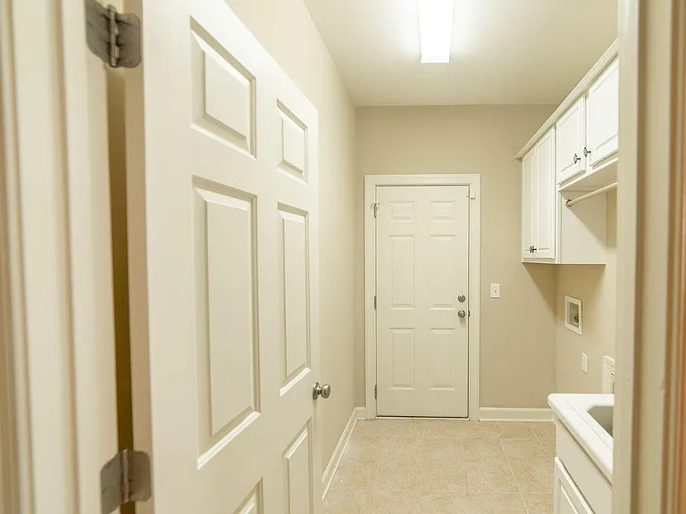 LAUNDRY ROOM WITH UTILITY SINK AND CABINETS