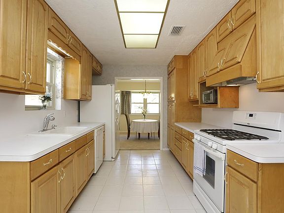 KITCHEN - You'll love the handsome custom cabinetry in this Kitchen. There are pull out drawers and a pantry to maximize storage space.