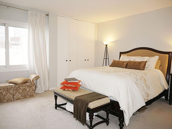 spacious master bedroom with city views