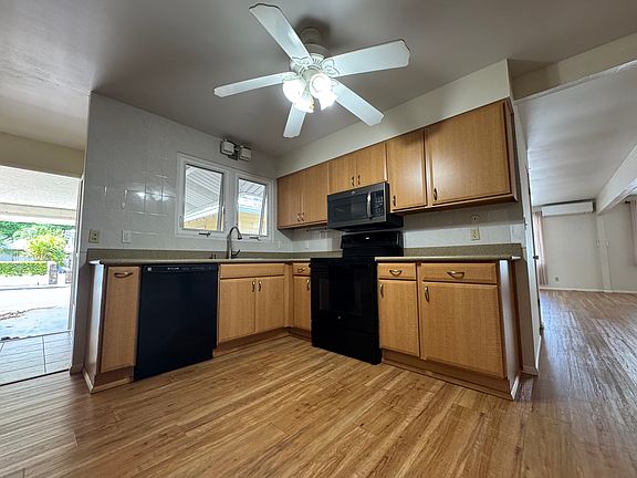 Large, open kitchen. Left is the door which leads to the carport for 2 cars. There are ample street parking also.