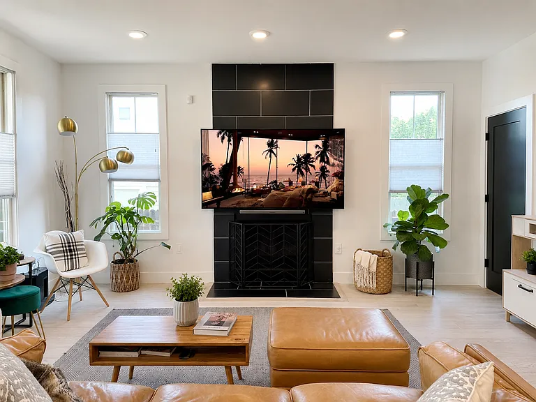 Gas fireplace, storage closet, and built in TV mount that opens to the kitchen.