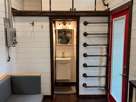 View from kitchen to sitting area, bathroom and storage loft