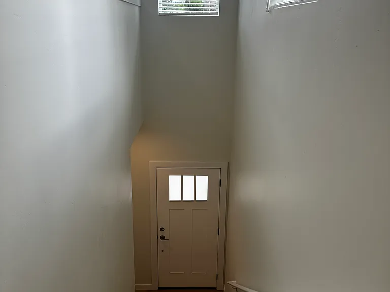 Walking down from living room to garage and street entrance.
