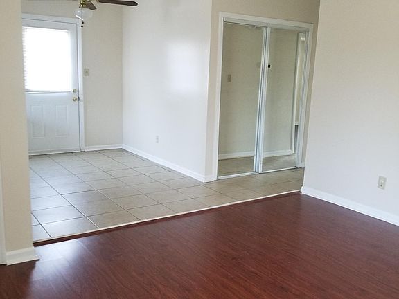 View of Dining room with ceiling fan and living room.