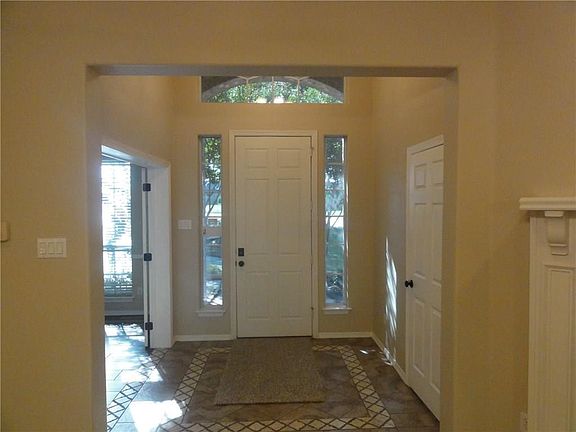 Front entry. Formal dining is on the right while the door on the left leads to an extra large storage space and coat closet.