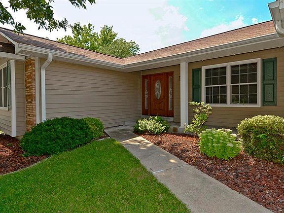 The exterior is brick and vinyl with enclosed soffits, custom front door and landscaping.
