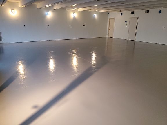 Front image with grey floors and white walls .