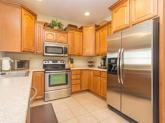 The kitchen features upgraded maple cabinets, high end stainless steal appliances, recessed lighting