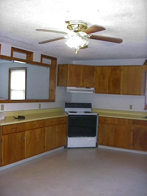 Kitchen looking into living room. Large open view, over the counter.