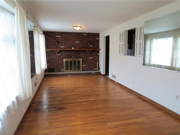 WELCOME INTO THE  OVER SIZED FAMILY ROOM THAT HAS ENDLESS POSSIBILITIES! THE TWO LARGE FRONT WINDOWS ALLOW THE SUNLIGHT TO POUR 