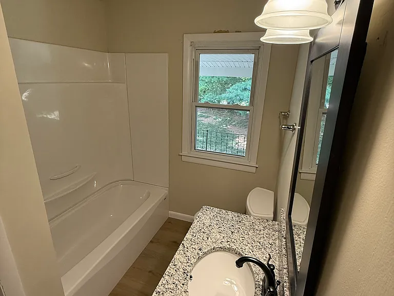 Large all new bathroom includes granite countertops, new luxury vinyl floors, and window