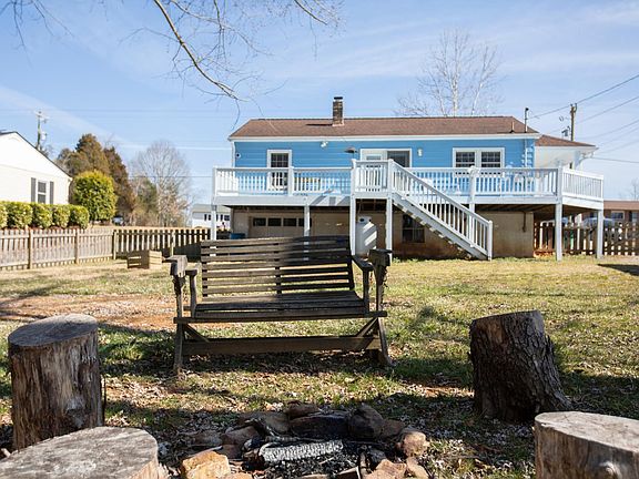 View from the fenced-in backyard. There is tons of storage in the ground level basement.