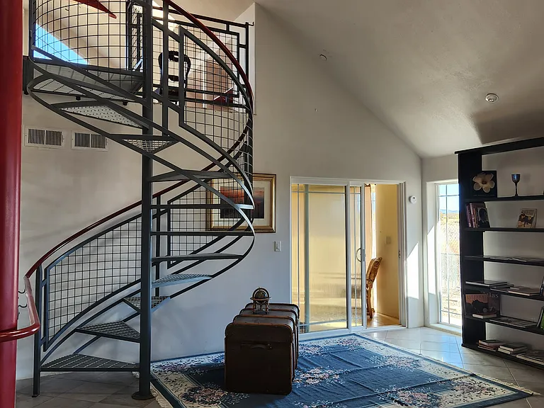 The spiral staircase and master bedroom main entrance from the breakfast bar.