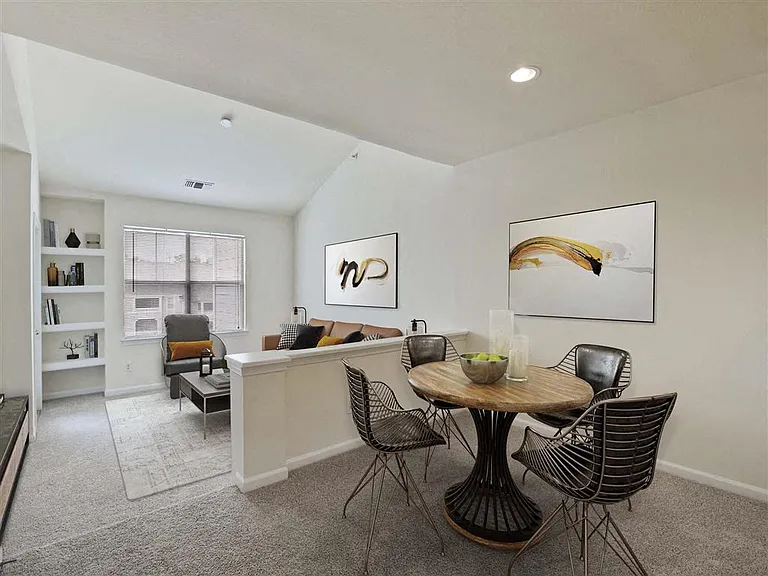 Large open living area with built in bookshelf and high ceilings at The Crossings at Russett in Laurel, MD