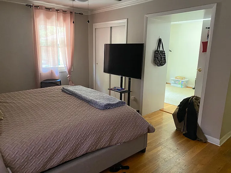 Master bedroom leading to bonus room and patio