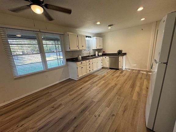 Kitchen is aprox 17.25'x12.75'. Includes gas stove, fridge, DW, countertop MW/airfryer/convection. Area for table/chairs and door to patio.