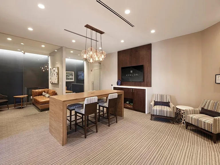 Business center with co-working pods and flat screen television
