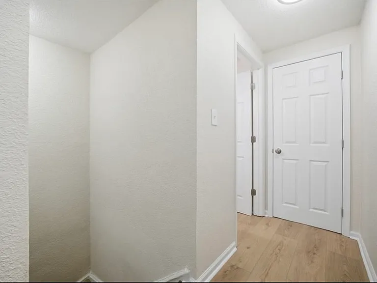 Top of stairs leading to bedrooms and bathroom