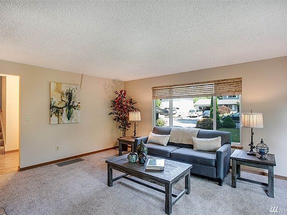 Here's another view of the living room looking back toward the entry. This room has been wired for surround-sound. You'll also appreciate new carpet here.