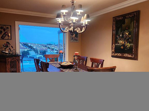 Formal Dining Room Leading to Backyard with Beautiful Wine Cabinet.
