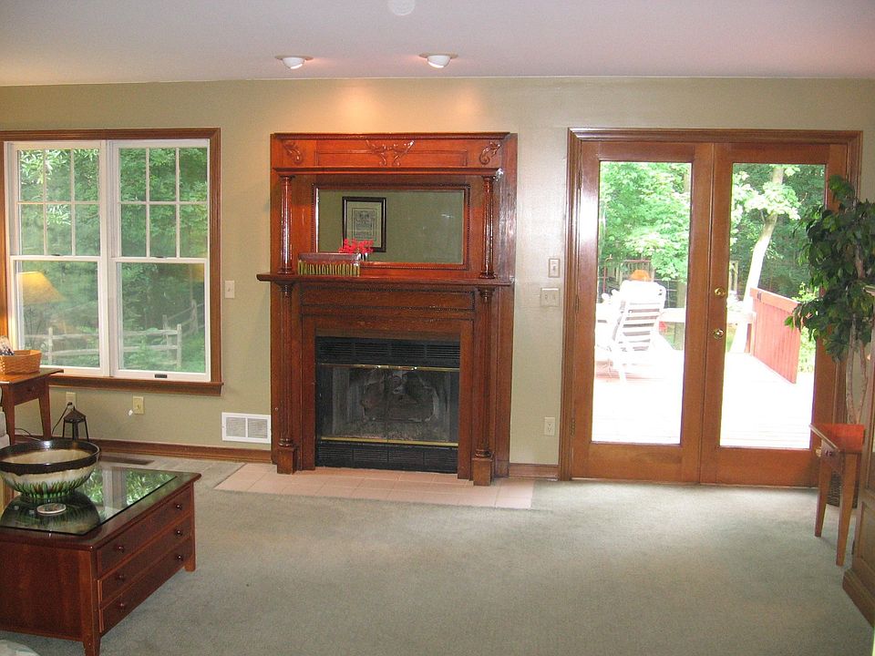 Family room with antique fireplace and views of woods
