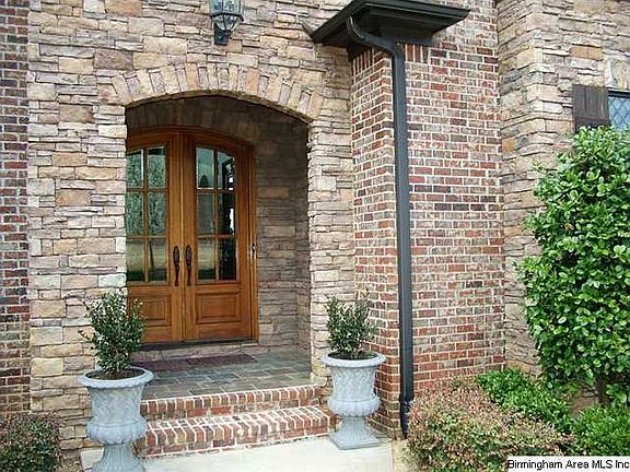 Welcoming, covered entrance with double doors and beveled glass panes.