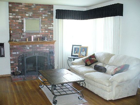 Living room with floor to ceiling brick fireplace