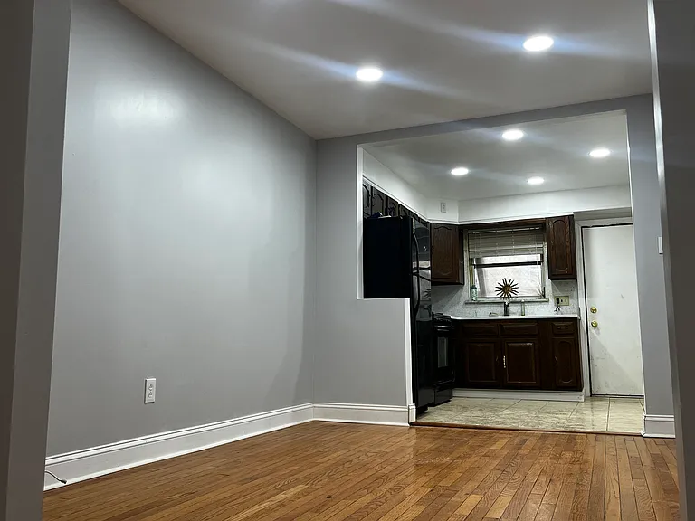 Dining space located between the living room and kitchen, featuring recessed lighting and hardwood floors and a closet on the right