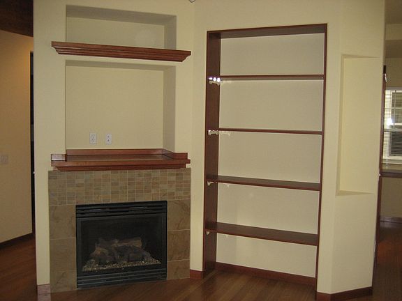 Fireplace in L.R. with TV shelf above.