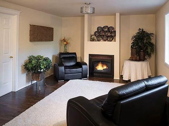 Newly stained hardwood floors and gas fireplace in the family room.