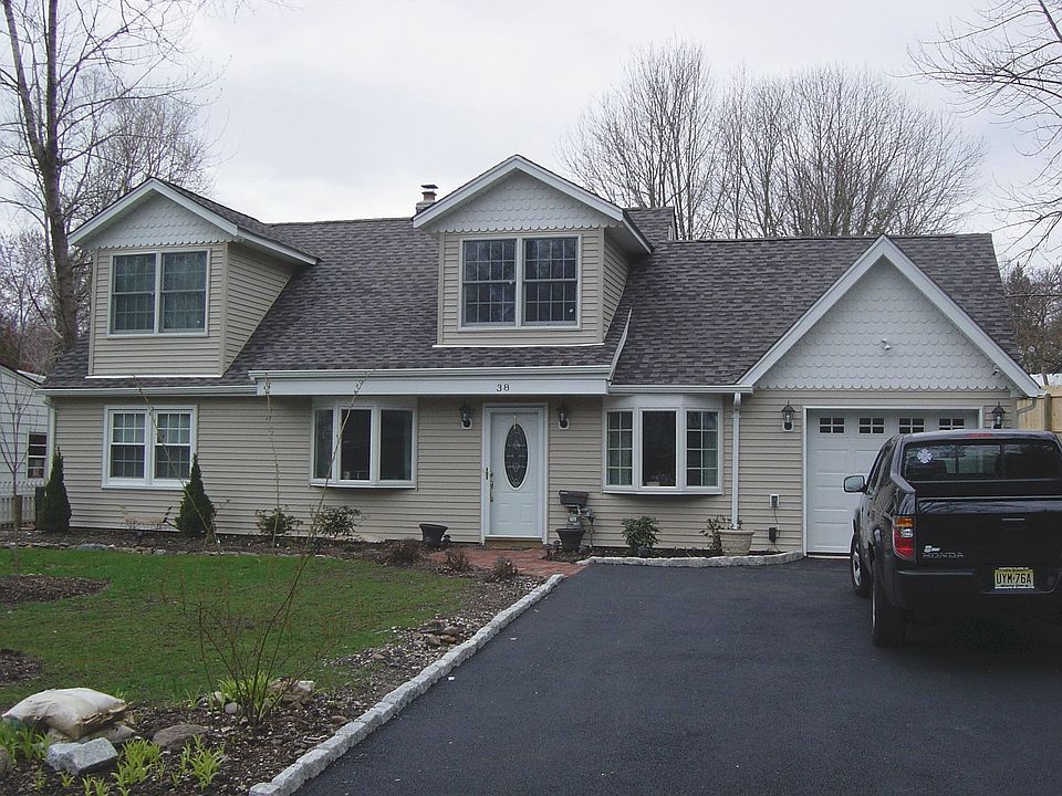 New siding, charming dormers, fresh pavement